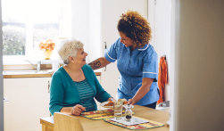 caregiver serving food to adult woman