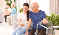 caregiver reading book with an adult man