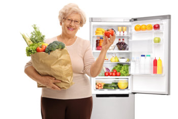 elderly woman holding groceries